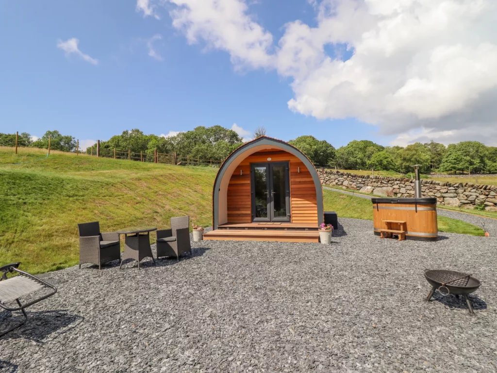 Eirlys Glamping Pod exterior with seating and fire pit, snowdonia