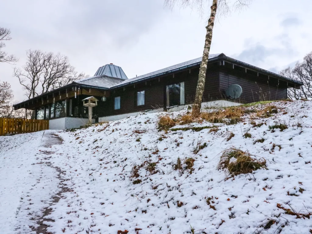 Katchana hot tub lodge, exterior with snow on the ground, aviemore in Scotland