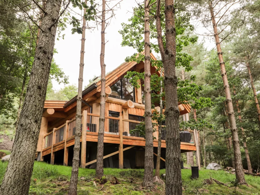 pine martin hot tub log cabin near aviemore, exterior view in the forest